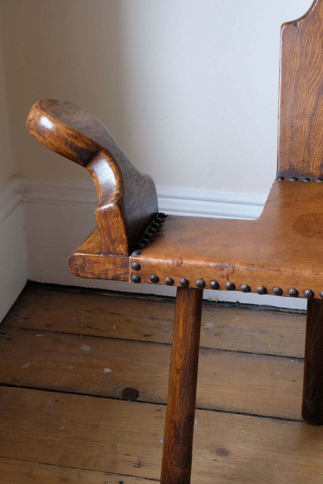 Detail of aged studded leather seat and patina