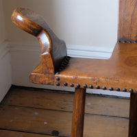 Detail of aged studded leather seat and patina