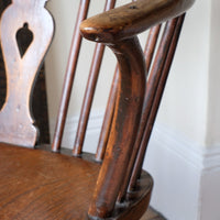 sweptback arms of a 19th Century Windsor Wheelback Armchair in Ash & Elm