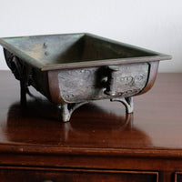 Close-up of dragon and cloud relief on Meiji Japanese bronze suiban vessel