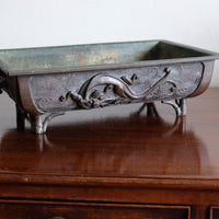 Close-up of dragon and cloud relief on Meiji Japanese bronze suiban vessel