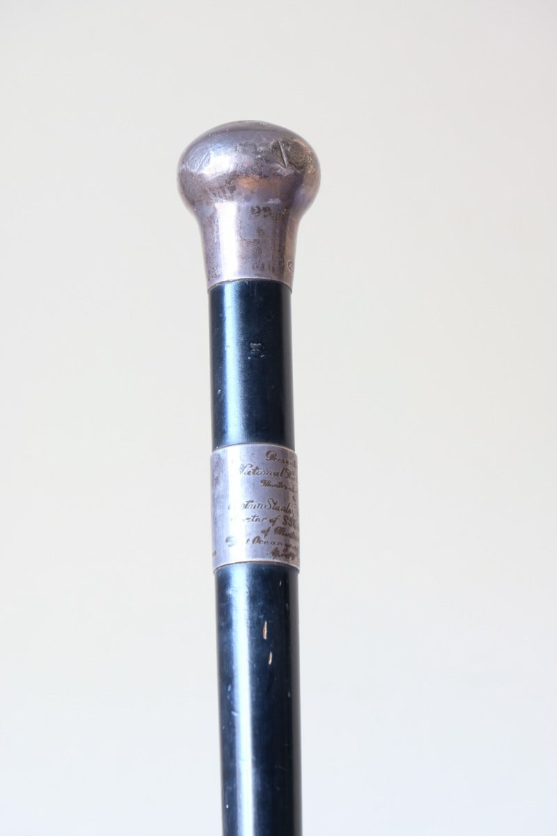 ebonised walking stick with hallmarked silver top and engraved plaque