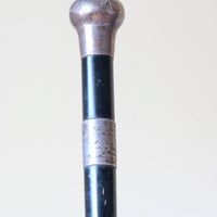 ebonised walking stick with hallmarked silver top and engraved plaque