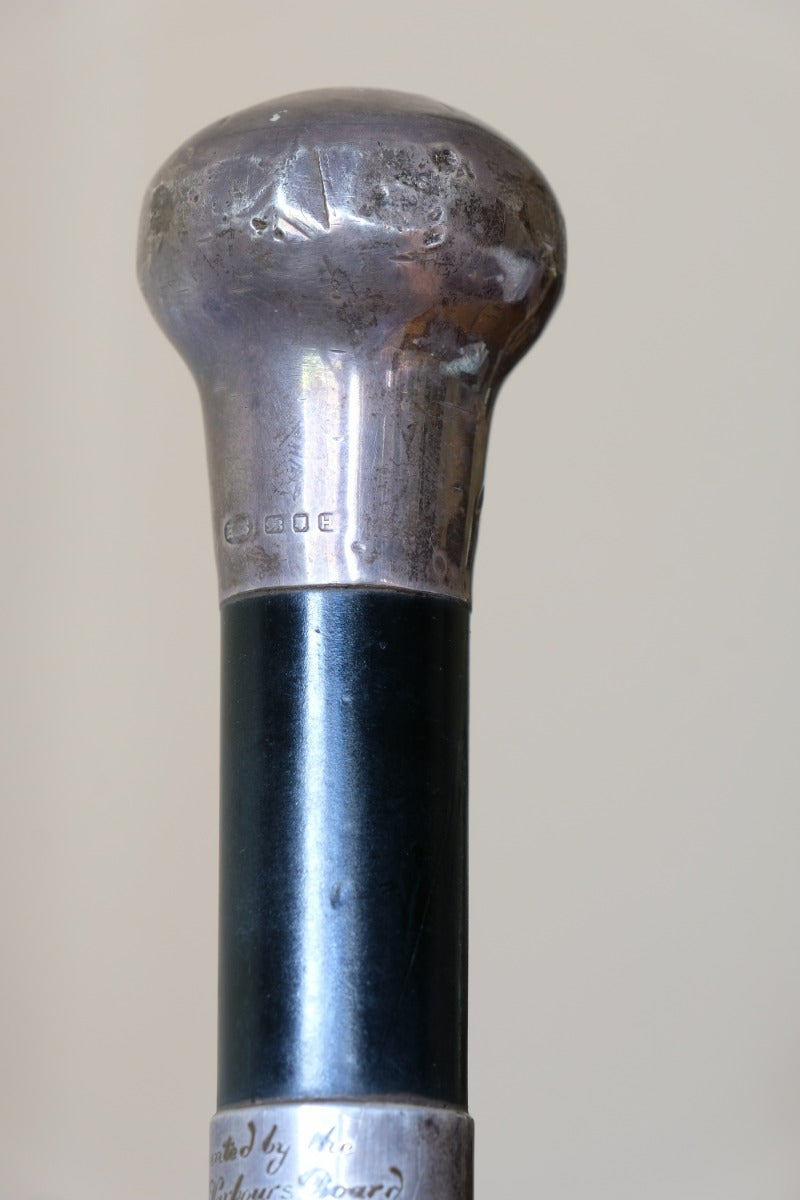 ebonised walking stick with hallmarked silver top and engraved plaque