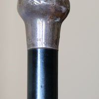 ebonised walking stick with hallmarked silver top and engraved plaque