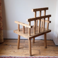 back view - Primitive handmade wooden armchair with rustic timber finish and blocky carved design
