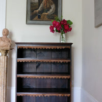 Edwardian carved oak bookcase with leather dust cover fringes