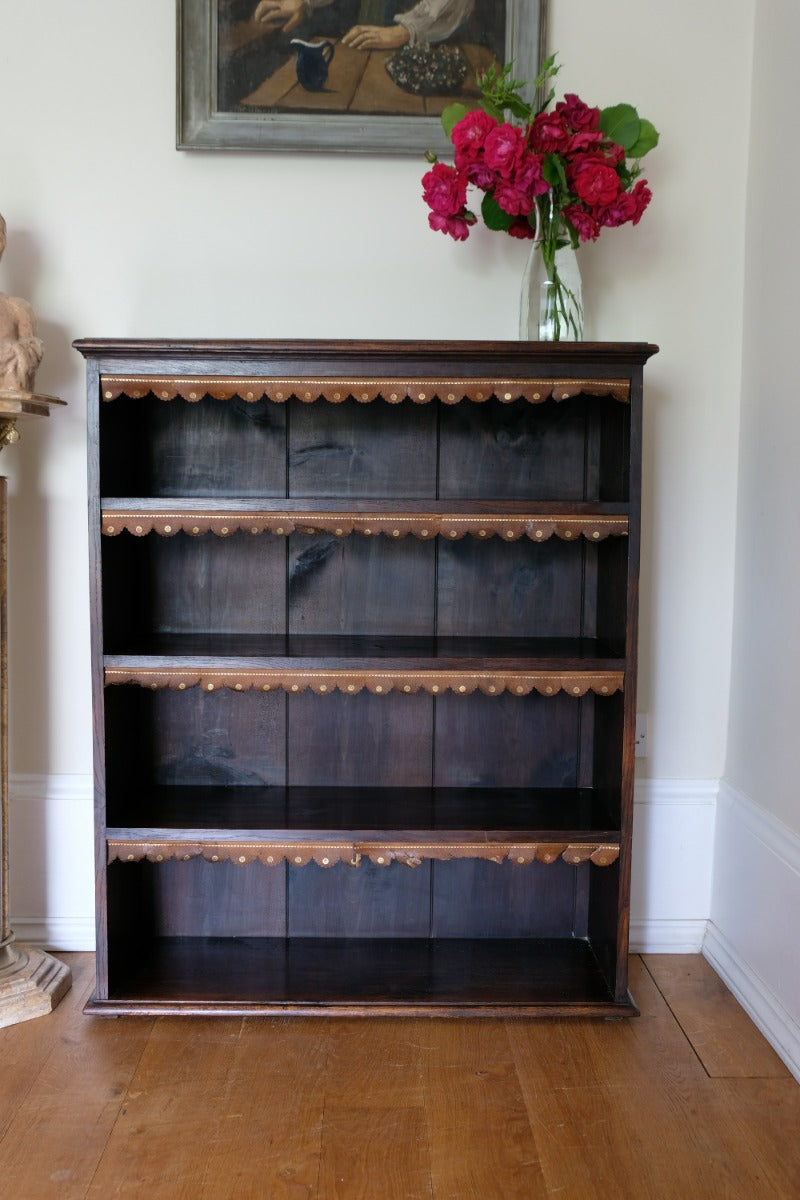 Edwardian carved oak bookcase with leather dust cover fringes