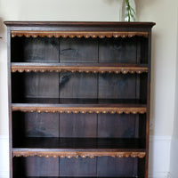 Edwardian carved oak bookcase with leather dust cover fringes