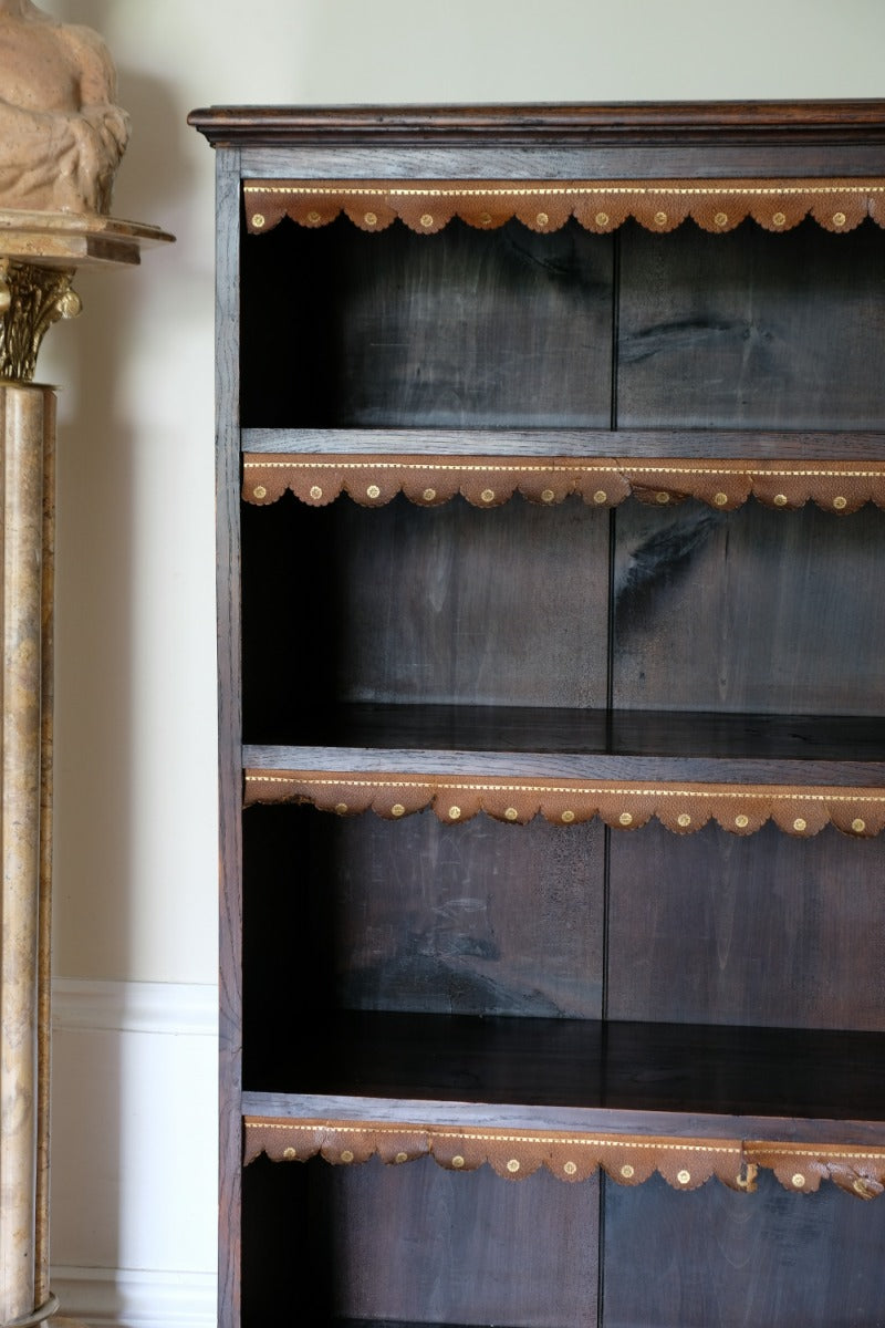 Original tooled leather scalloped fringe on fixed oak shelf