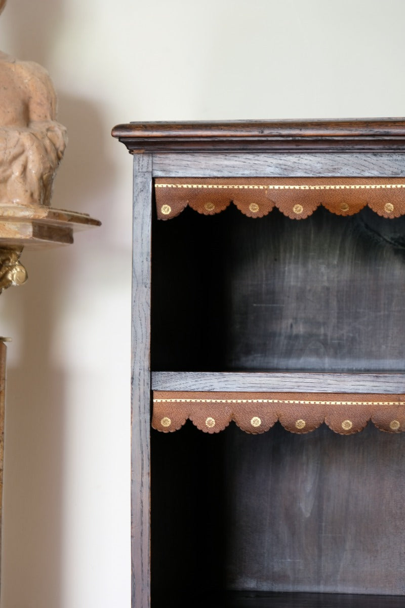 Edwardian carved oak bookcase with leather dust cover fringes