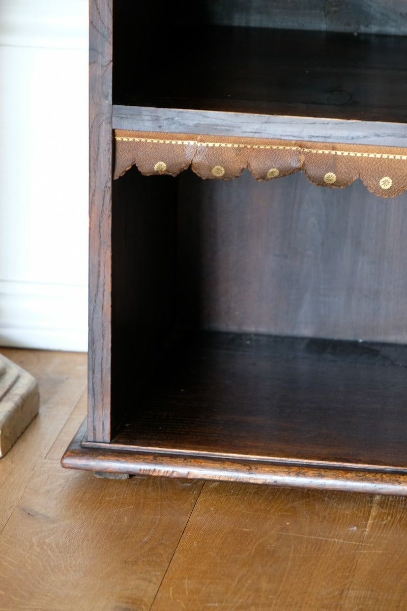 Edwardian carved oak bookcase with leather dust cover fringes
