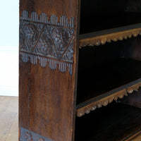 Edwardian carved oak bookcase with leather dust cover fringes