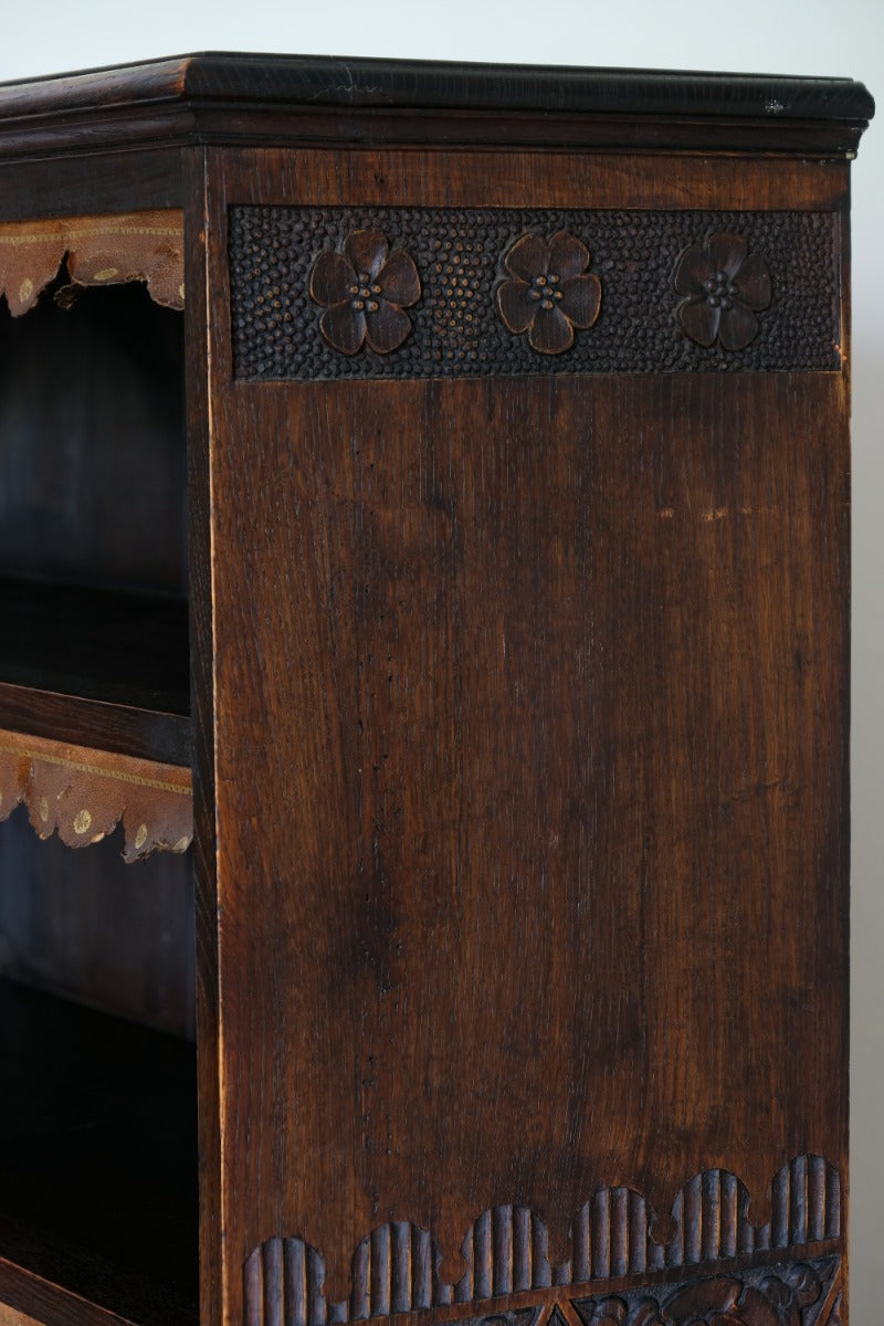Edwardian carved oak bookcase with leather dust cover fringes