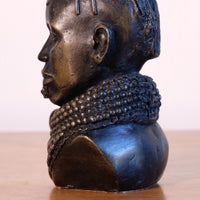 sculpture with textured beaded neck adornment