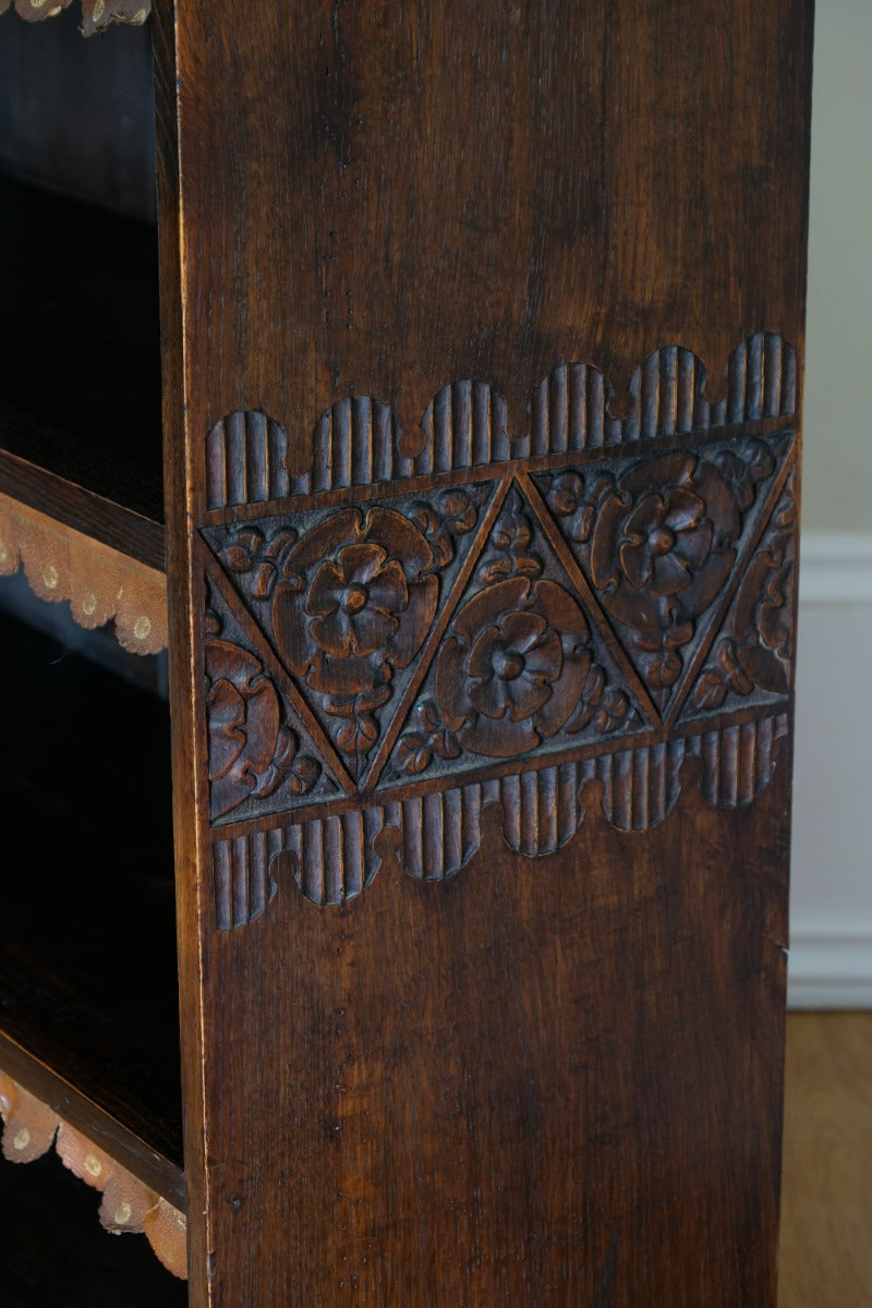 Edwardian carved oak bookcase with leather dust cover fringes