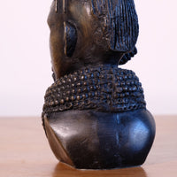 sculpture with textured beaded neck adornment