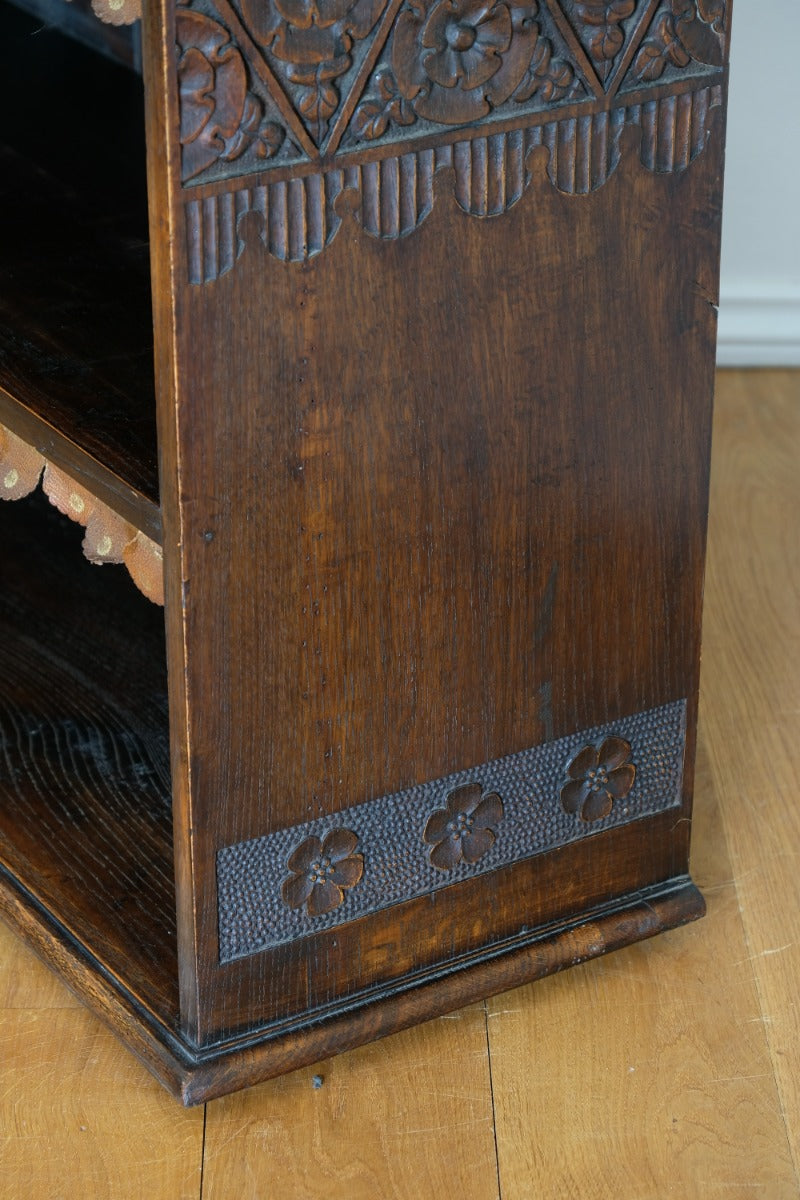 Edwardian carved oak bookcase with leather dust cover fringes