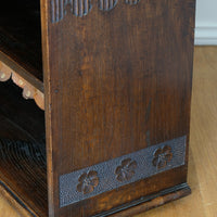 Edwardian carved oak bookcase with leather dust cover fringes