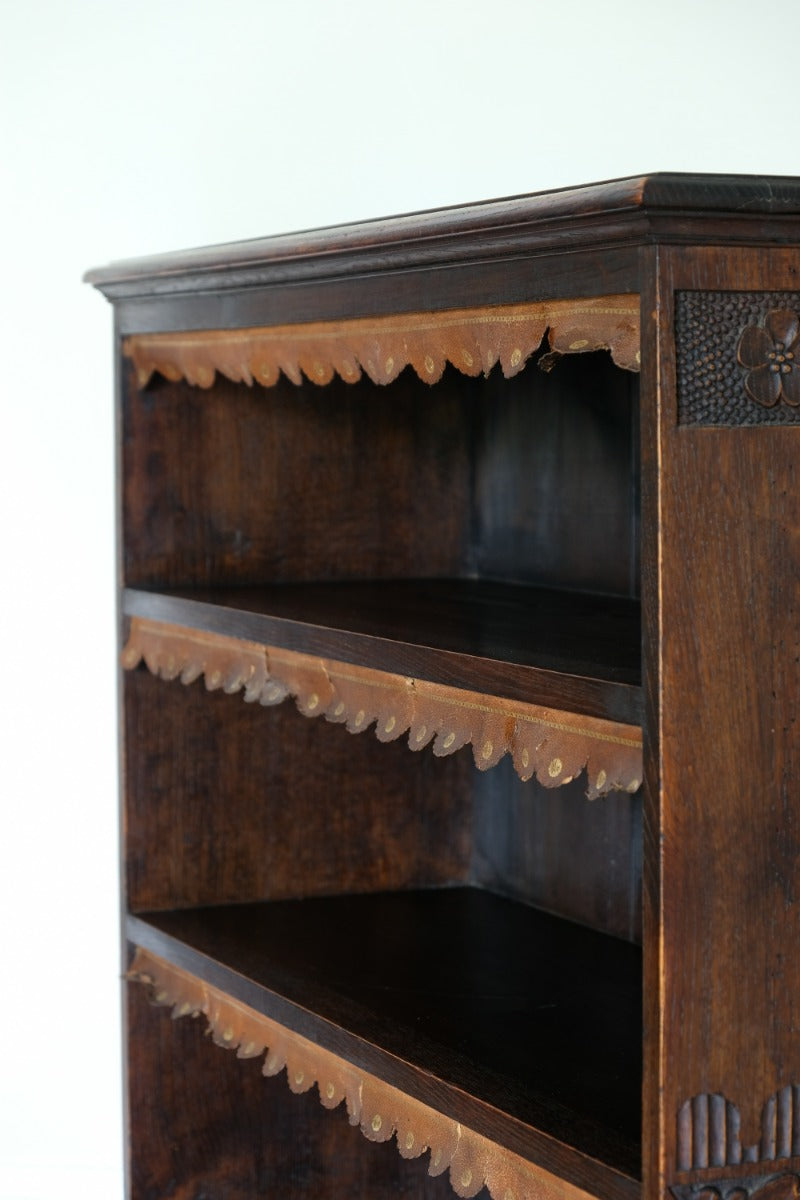Edwardian carved oak bookcase with leather dust cover fringes
