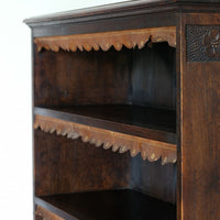 Edwardian carved oak bookcase with leather dust cover fringes