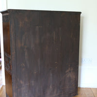 back of the Edwardian carved oak bookcase with leather dust cover fringes