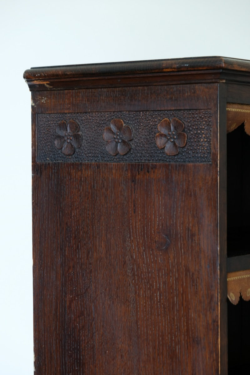 Edwardian carved oak bookcase with leather dust cover fringes