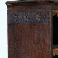 Edwardian carved oak bookcase with leather dust cover fringes