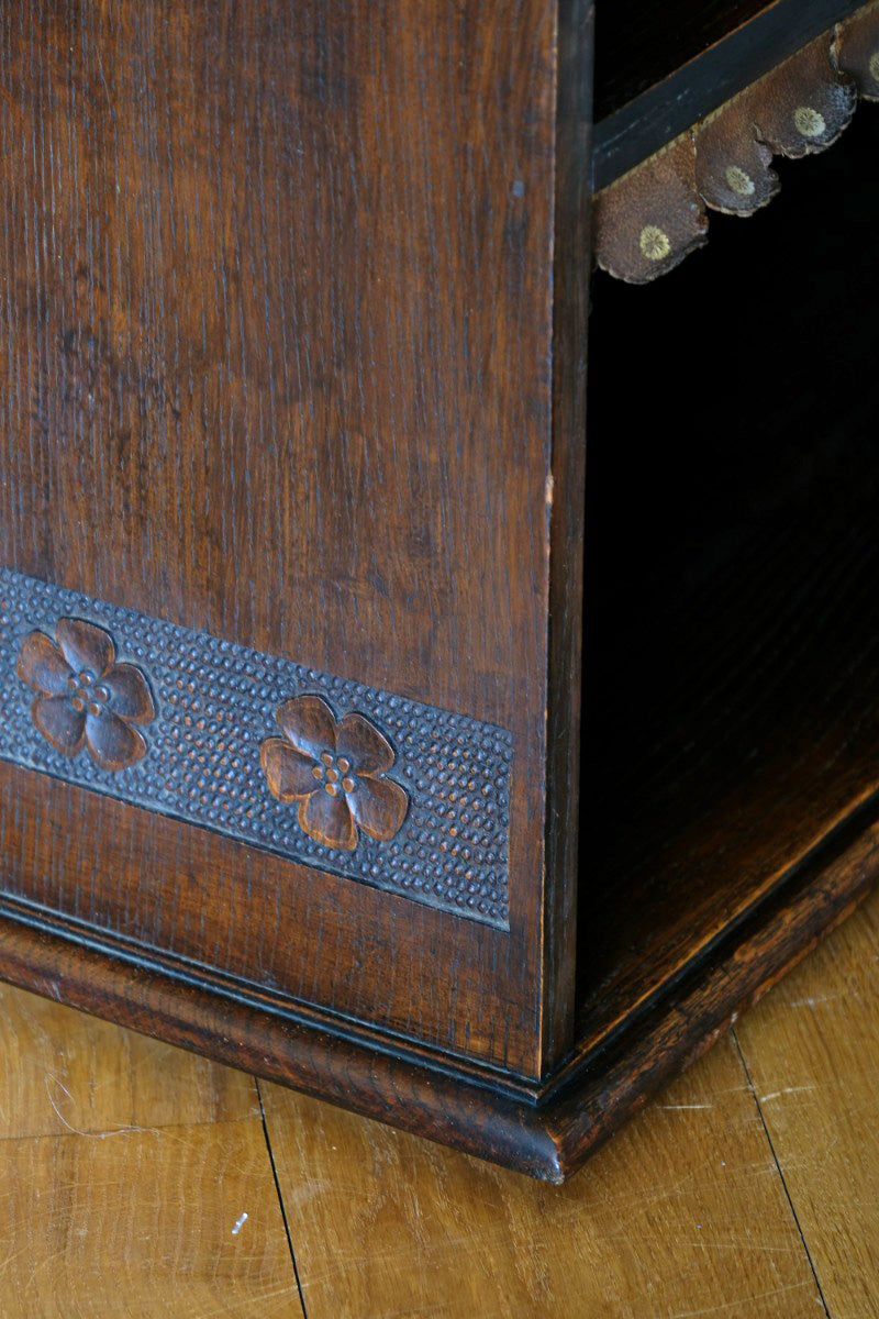 Edwardian carved oak bookcase with leather dust cover fringes