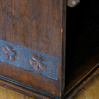 Edwardian carved oak bookcase with leather dust cover fringes