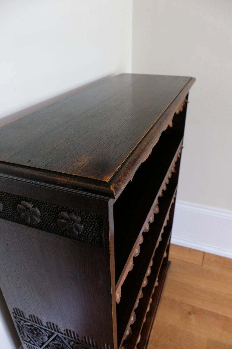 Edwardian carved oak bookcase with leather dust cover fringes