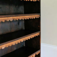 Edwardian carved oak bookcase with leather dust cover fringes