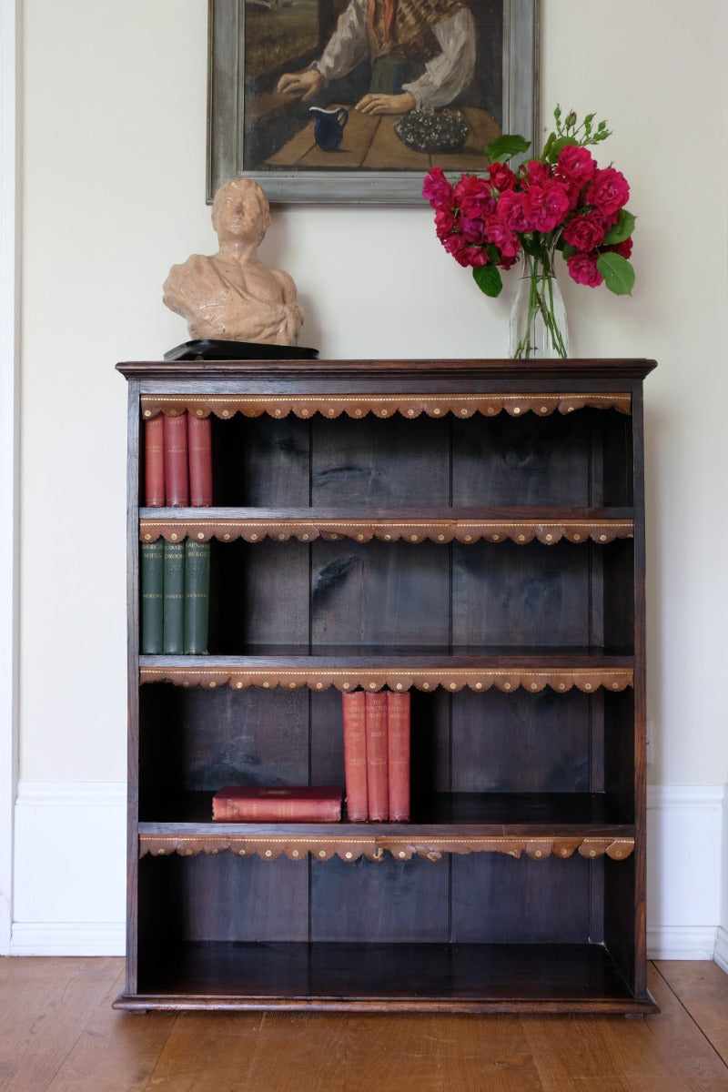 Edwardian carved oak bookcase with leather dust cover fringes