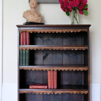 Edwardian carved oak bookcase with leather dust cover fringes