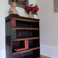 Edwardian carved oak bookcase with leather dust cover fringes
