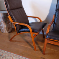curved arm of a Pair of 1970s Danish Stouby bentwood leather lounge chairs with sculptural oak frame