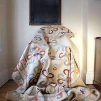 Vintage Uzbek Suzani kilim rug with embroidered floral medallions and vine scroll border, 173 x 230cm