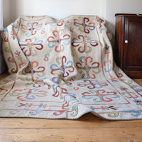 Vintage Uzbek Suzani kilim rug with embroidered floral medallions and vine scroll border, 173 x 230cm