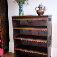 With out books Edwardian Arts and Crafts carved oak bookcase with original tooled leather dust fringing shelves