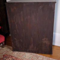 Three panelled back of a Edwardian Arts and Crafts carved oak bookcase with original tooled leather dust fringing shelves