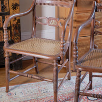Pair of Regency mahogany armchairs with brass inlay and cane seats, circa 1810