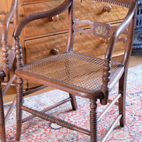 Pair of Regency mahogany armchairs with brass inlay and cane seats, circa 1810