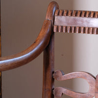 close up on a Pair of Regency mahogany armchairs with brass inlay and cane seats, circa 1810