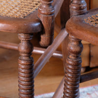 Bobbin legs on a Pair of Regency mahogany armchairs with brass inlay and cane seats, circa 1810