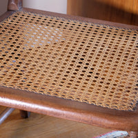 cane seat on a Bobbin stretcher on a Pair of Regency mahogany armchairs with brass inlay and cane seats, circa 1810