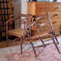 Pair of Regency mahogany armchairs with brass inlay and cane seats, circa 1810