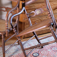 Pair of Regency mahogany armchairs with brass inlay and cane seats, circa 1810