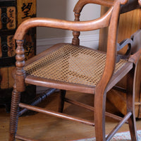 Pair of Regency mahogany armchairs with brass inlay and cane seats, circa 1810