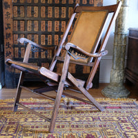 side view of a Victorian brass studded leather folding campaign chair reclining armchair circa 1875