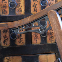 close up pf a Victorian brass studded leather folding campaign chair reclining armchair circa 1875